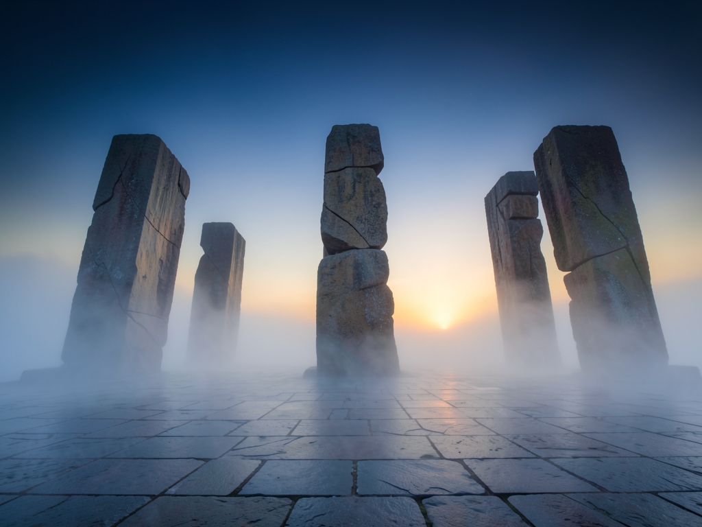 vast mist shrouded stone plaza where five towering monoliths