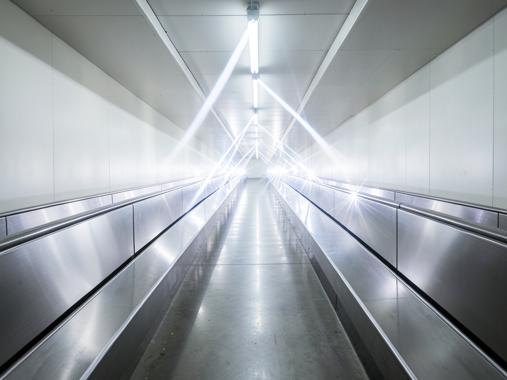 sleek industrial corridor stretches into distance with brushed