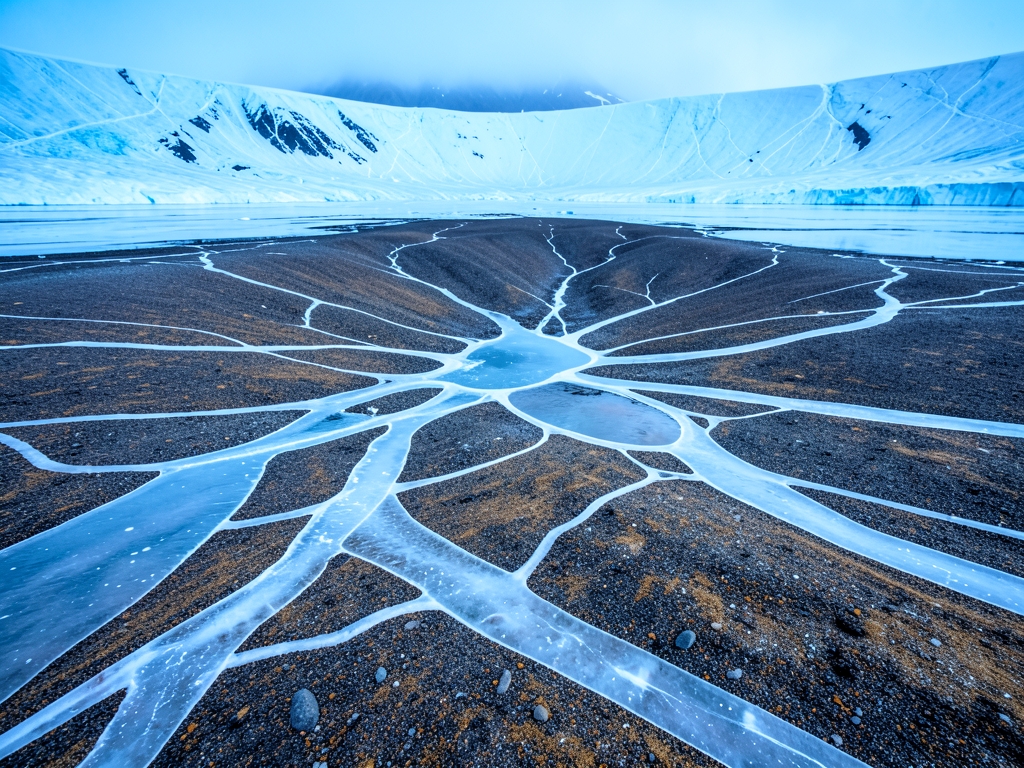 Beneath vast translucent Antarctic sheet branching meltwater channels