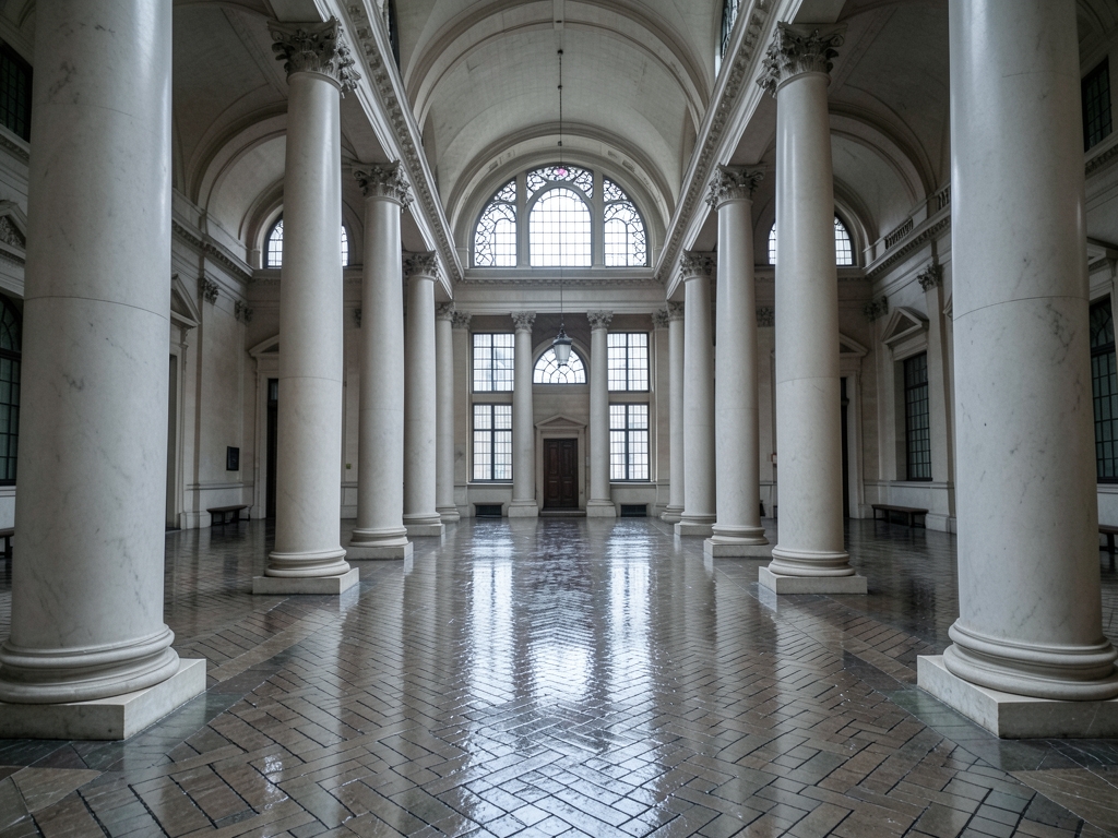 vast European courthouse atrium with pale marble columns