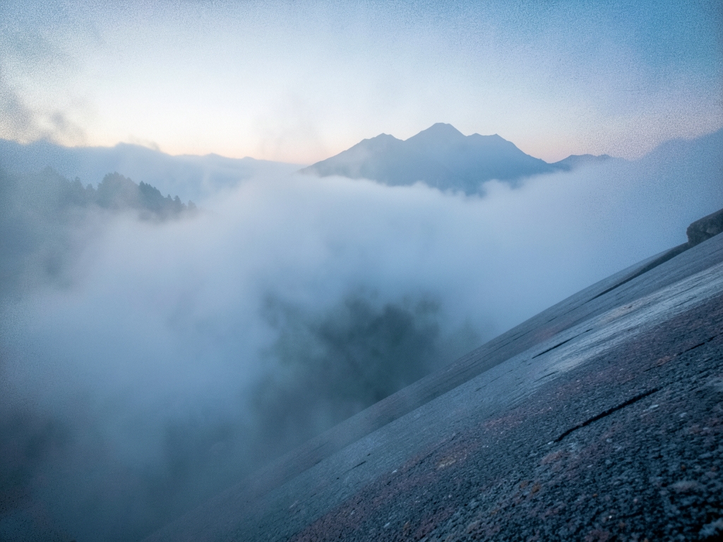 vast fog covered mountain range dawn soft diffused light
