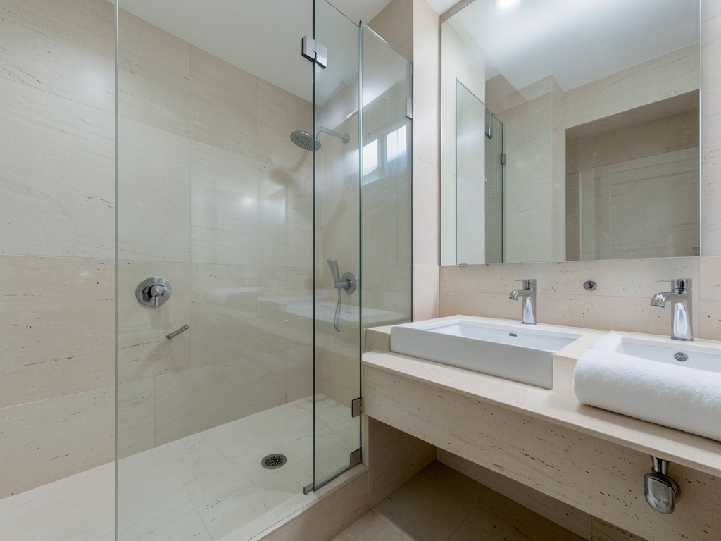 Immaculate modern bathroom under overcast daylight pale stone