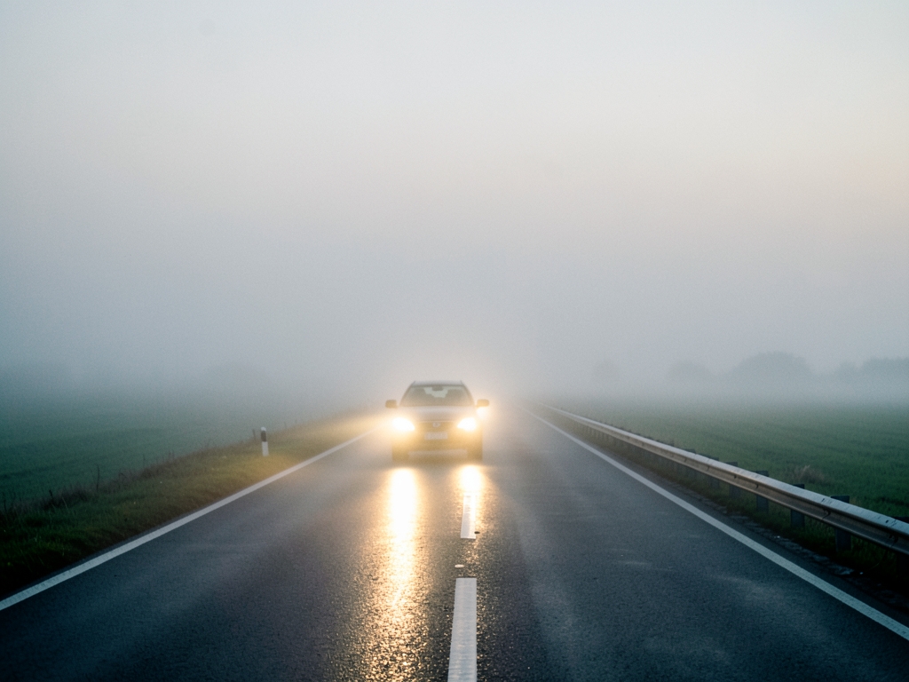 misty European motorway vanishing into flat landscape dawn