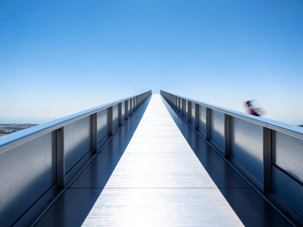 long straight elevated walkway brushed aluminum stretching into