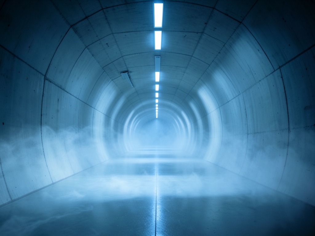 vast concrete wind tunnel pale blue light from