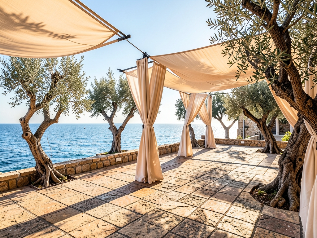 Sunlit stone hotel terrace with linen canopies olive