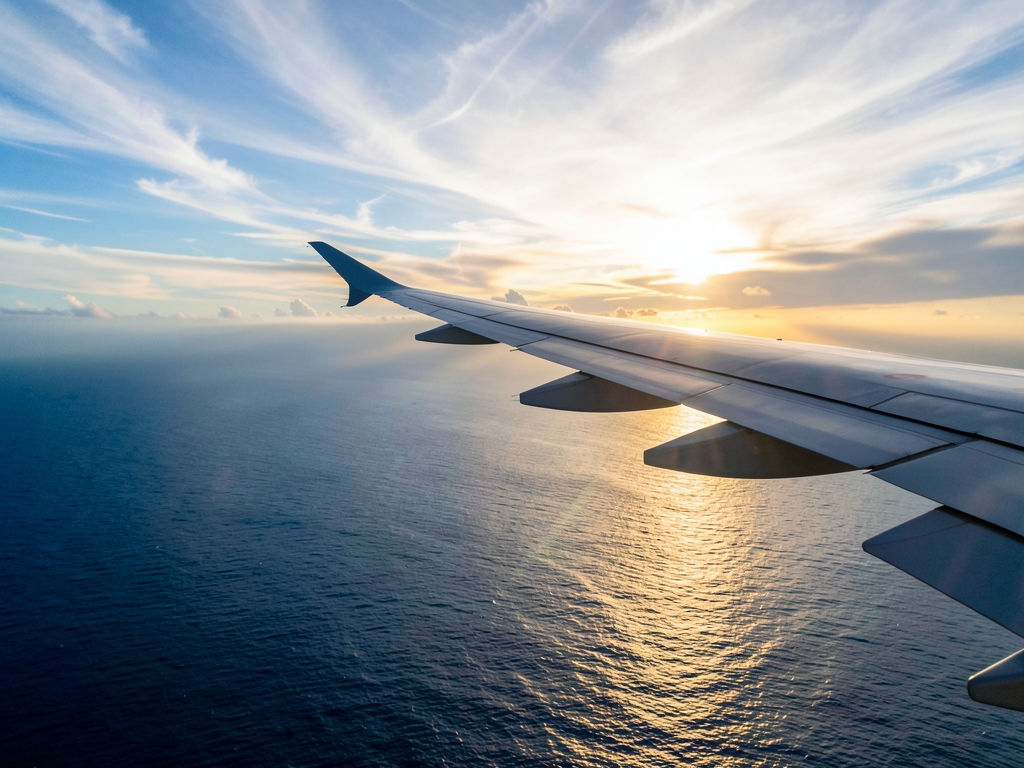 Jakarta to Singapore flight corridor over tropical sunrise cloud banks