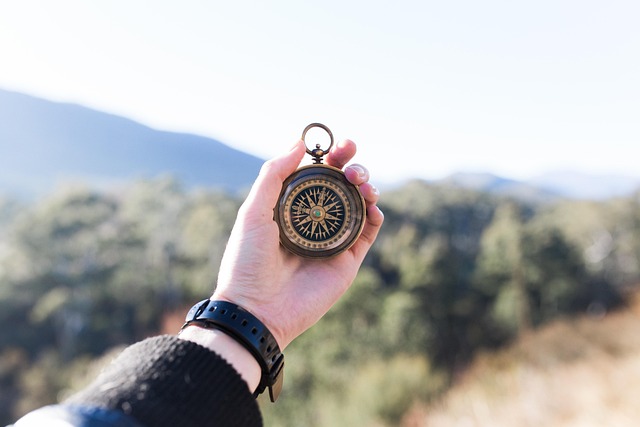 compass hand holding outdoors adventure travel navigation navigate direction north heading south east west hand adventure ad