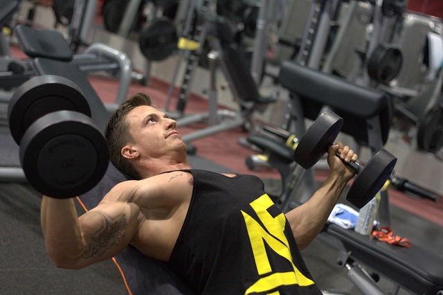 man training dumbbells strengthening muscles gym fitness athlete muscular sport exercise bodybuilder gym bodybuilder bodybuild