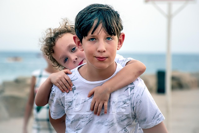 brothers siblings family together embrace kids outdoor at the beach little brother brotherhood holding happiness eyes cute two