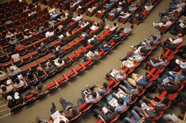 event venue auditorium meeting forum conference listener audience public people sit watching