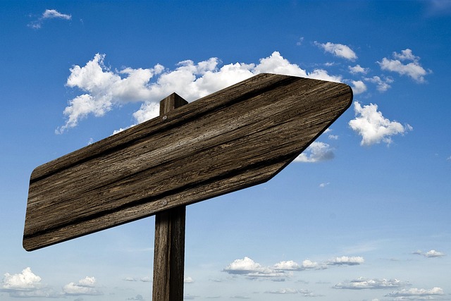 signpost waypoint wood grain board sign direction right path marking arrow nature heaven clouds