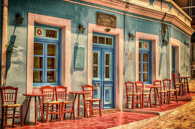 cafe building greece karpathos island facade architecture chairs tables front windows nature door restaurant empty closed str