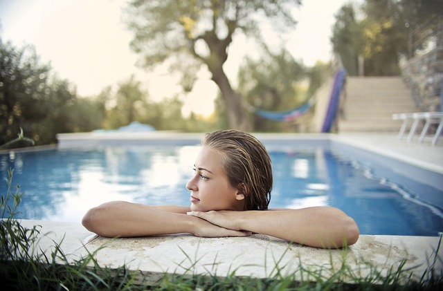 woman blonde young the person nice swimming pool pool the water reflections trees nature out the nature grass