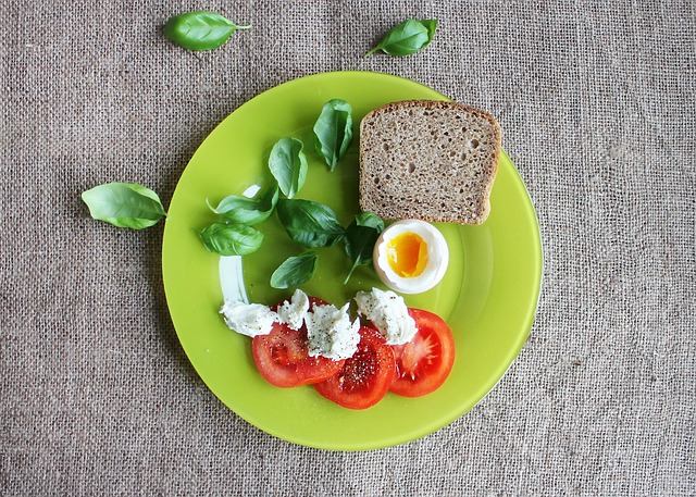 tomatoes eggs toast dish plate food fresh basil leaves slice of bread tomato slices healthy boiled egg soft boiled egg healthy
