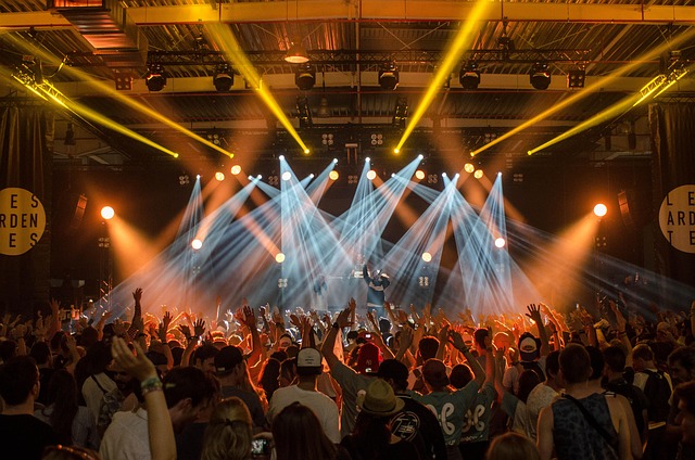 audience band concert crowd festival lights music musicians people performance stage stage lights event live event celebration