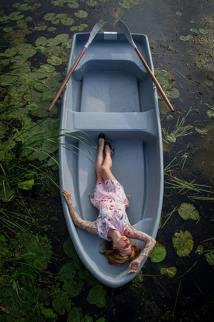 boat river woman nature young lake water lilies water harmony young woman summer lie paddles the girl in the boat girl in a bo