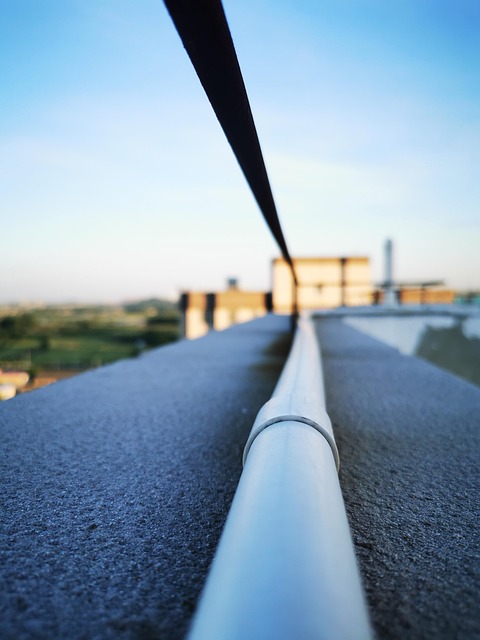railing extend blue sky distance house