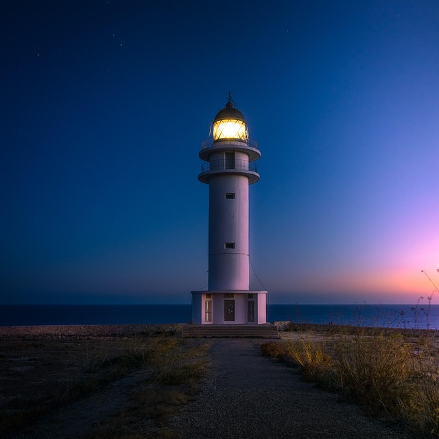 beach lighthouse coast light illuminated beacon navigation tower watchtower ocean sea nature seashore signal light signal sun