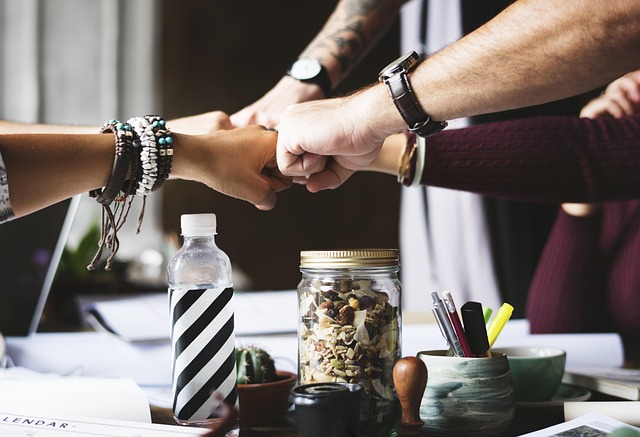 action collaborate collaboration colleagues cooperation corporate fist bump partner people person small business support team t