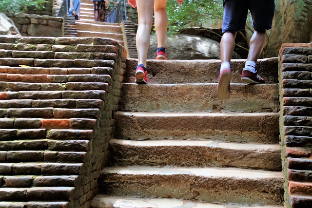 couple legs climbing stairs outside architecture step together temple monument walk footwear two old travel tour rest lands