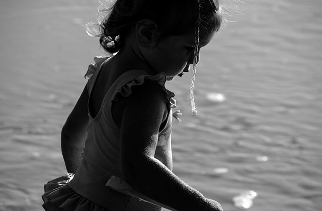 child monochrome light shadow holiday over the water